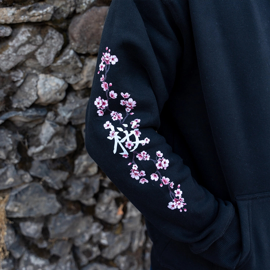 ArcaLoot Sakura black hoodie sleeve with Japanese lettering for Sakura and cherry blossoms artwork.