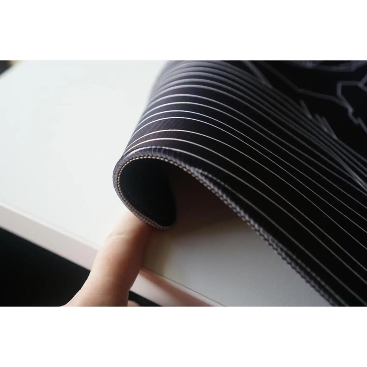 Large ArcaLoot gaming mousepad curled to show the stitched edging. Bare Boned Expedition.