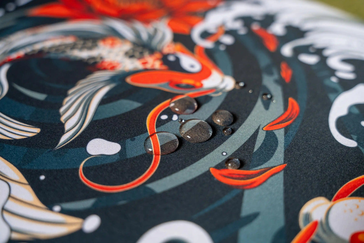 Water droplets on Arcaloot gaming mousepad featuring a koifish design. Rippled Tranquillity.