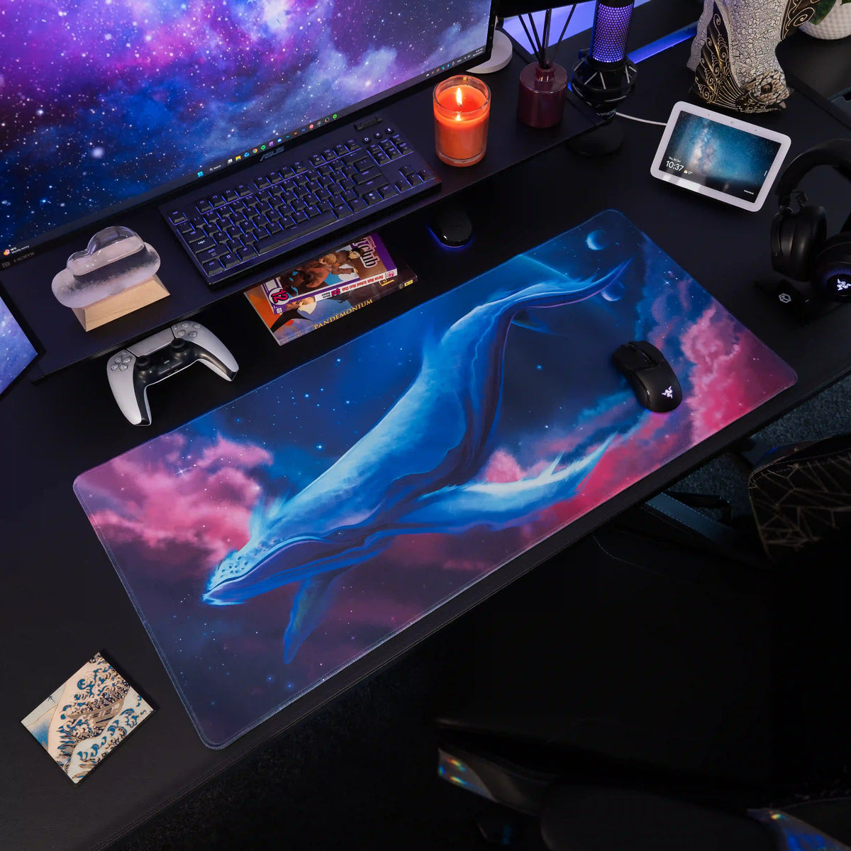 Large ArcaLoot gaming mousepad with a blue whale design against a colorful cosmic background on a black gaming desk. Cosmic Cetacean.