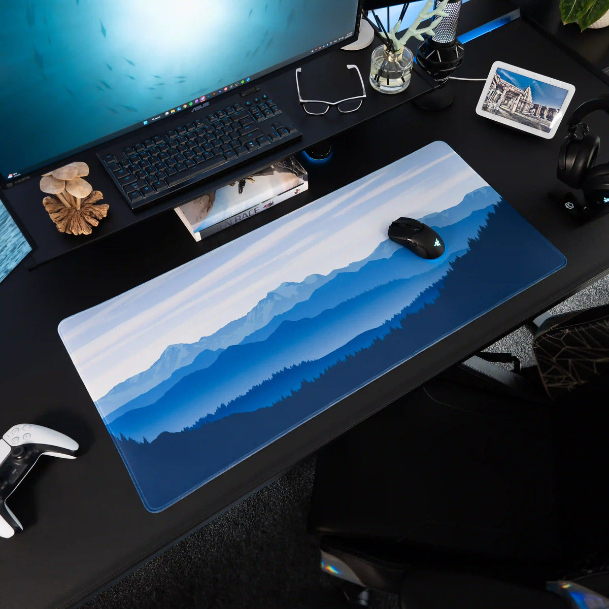 Large ArcaLoot gaming mousepad featuring blue mountains and a beautiful sky on a black gaming desk. Sapphire Summits.