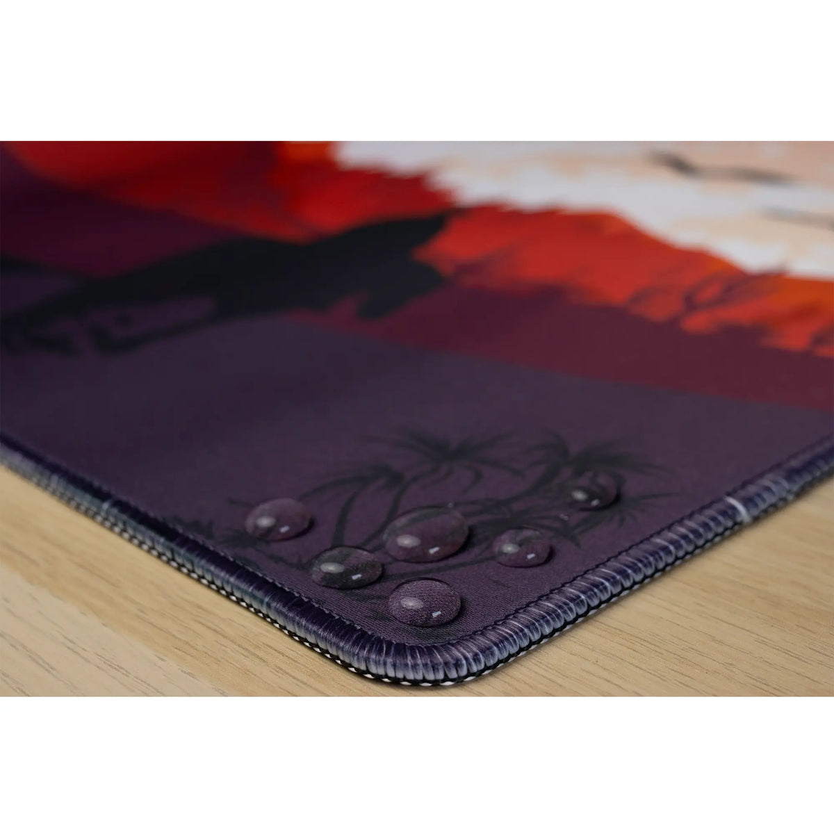 Clear water droplets on an arcaLoot Gaming Mousepad featuring a western desert landscape design. Sunset Wrangler.