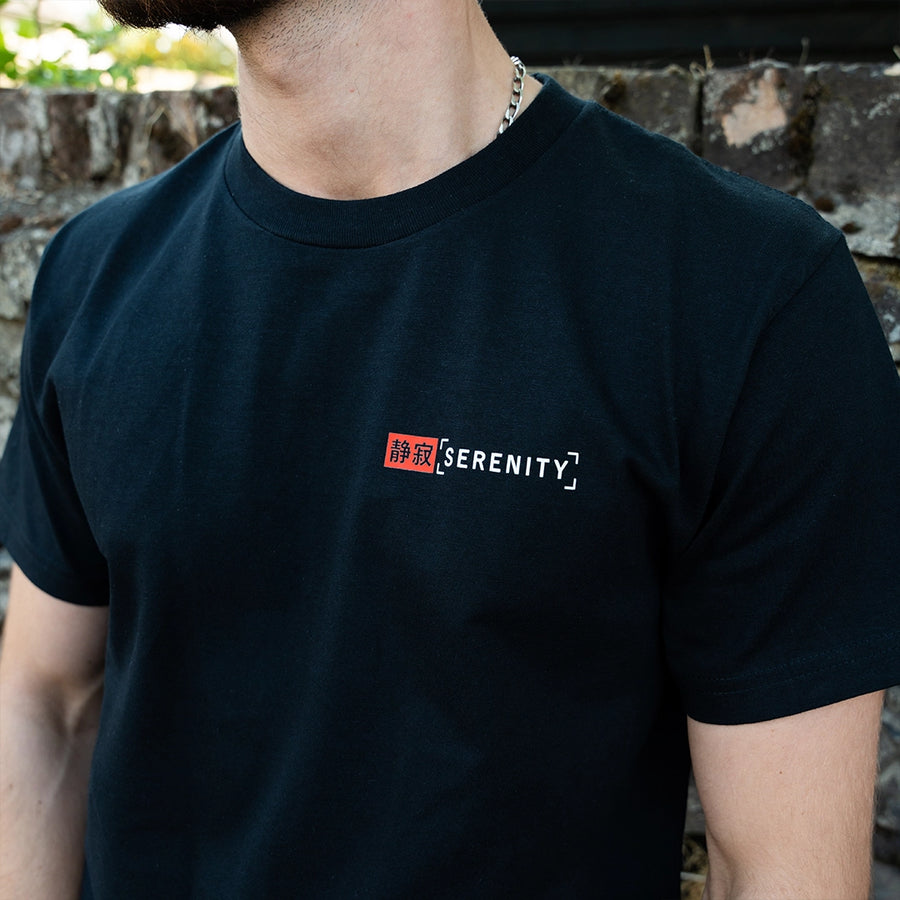 ArcaLoot Serenity black T-shirt with Japanese and English front logo, worn by a model.