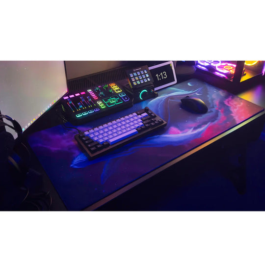 Large ArcaLoot gaming mousepad with a blue whale design against a colorful cosmic background on a black gaming desk. Cosmic Cetacean.
