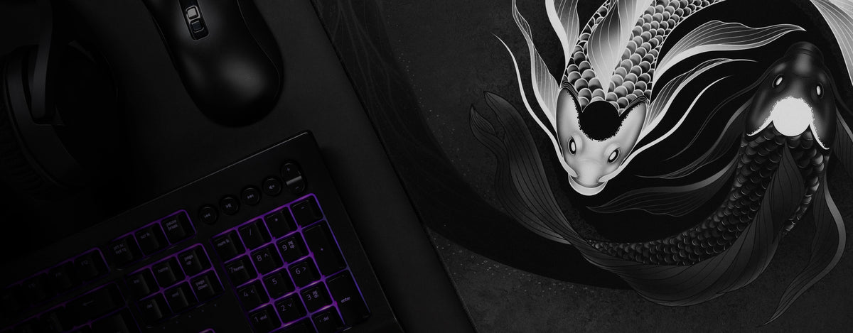 ArcaLoot Eternal Harmony mousepad on a desk with a mouse, keyboard and a part of a headset being seen. Artfully placed with dark shadows.