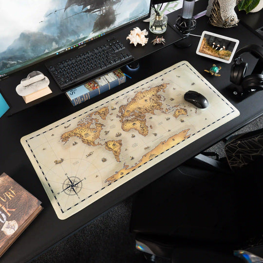 Decorative desk setup with a Large Arcaloot gaming mousepad featuring a world map design. Unchartered Earth. Fantasy Map.