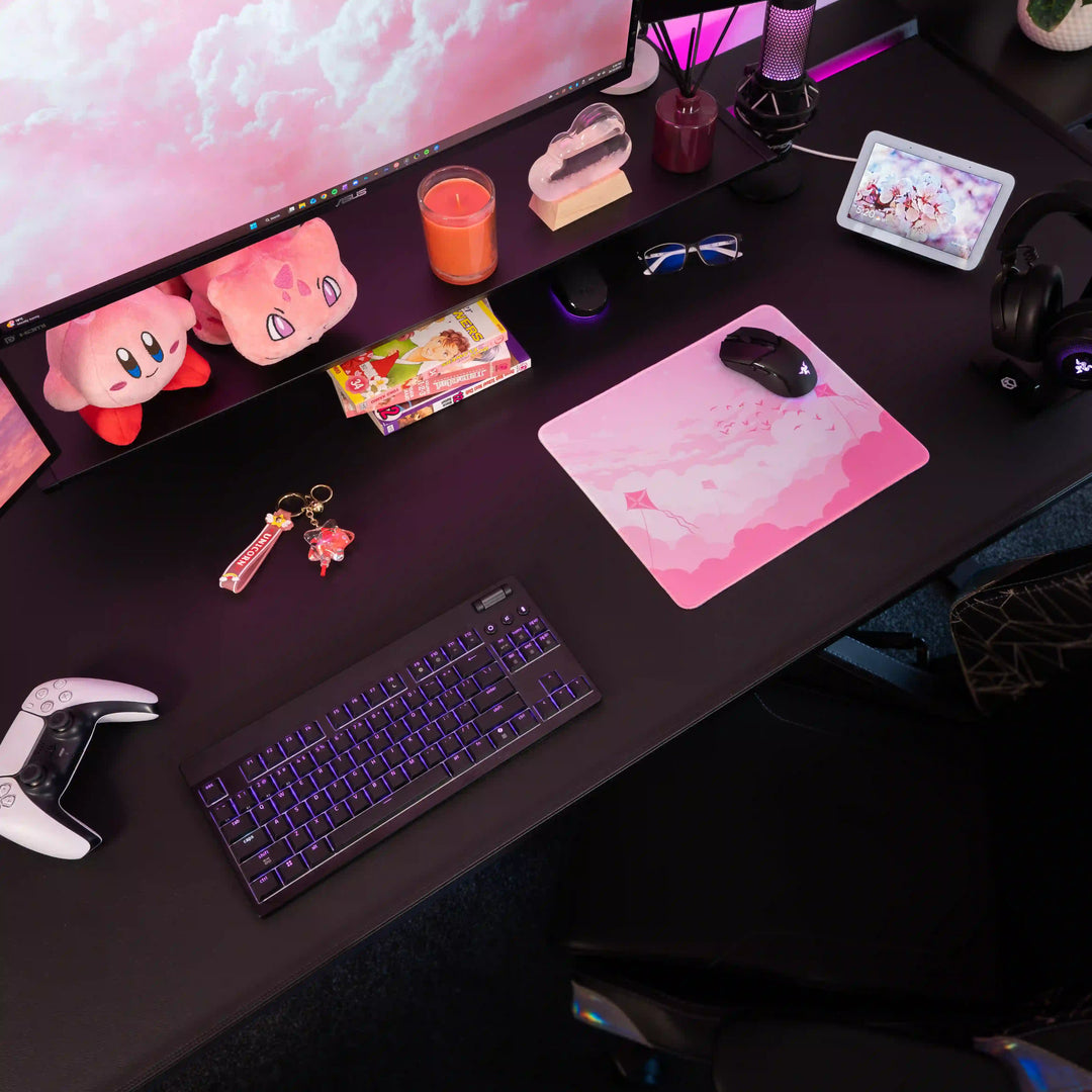 Small ArcaLoot gaming mousepad with pink sky and clouds design on a black gaming setup. Pink Dreams.