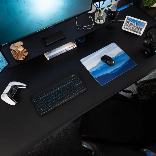 Small ArcaLoot gaming mousepad featuring blue mountains and a beautiful sky on a black gaming desk. Sapphire Summits.