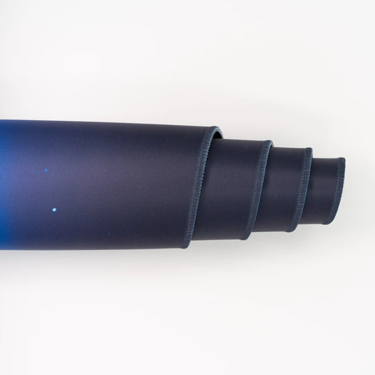 ArcaLoot Gaming Mousepad curled to show premium stitched edges - AussieAntics Alpine Aurora