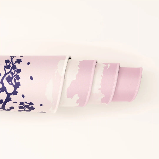 ArcaLoot Gaming Mousepad curled to show premium stitched edges - Sakura Cityscape