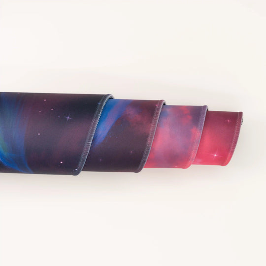 ArcaLoot Gaming Mousepad curled to show premium stitched edges - Cosmic Cetacean