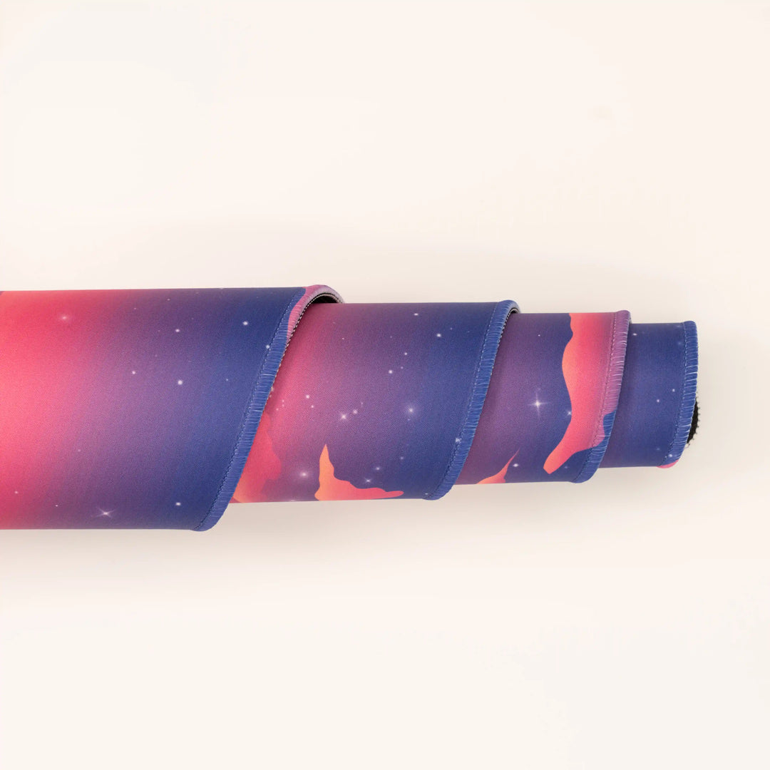 ArcaLoot Gaming Mousepad curled to show premium stitched edges - Rainbow Valley