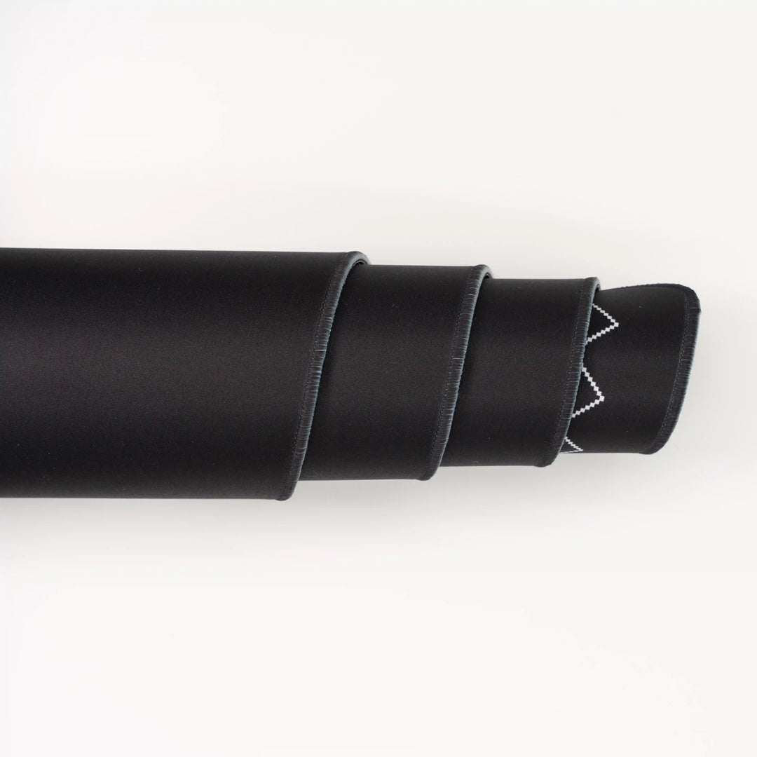 ArcaLoot Gaming Mousepad curled to show premium stitched edges - Black Abyss