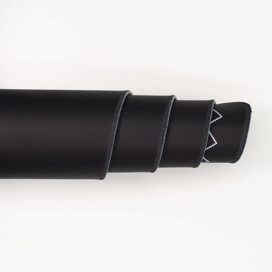 ArcaLoot Gaming Mousepad curled to show premium stitched edges - Black Abyss